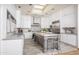 Bright kitchen features white cabinets, skylight, stainless steel appliances, and a center island at 8817 N 58Th Pl, Paradise Valley, AZ 85253