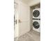 Bright laundry room features a stacked washer and dryer, tile flooring, and neutral paint tones at 8817 N 58Th Pl, Paradise Valley, AZ 85253