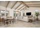 Open living area with beamed ceilings, neutral furniture, tile flooring, and backyard access at 8817 N 58Th Pl, Paradise Valley, AZ 85253