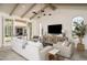 Comfortable living room with neutral furnishings, beamed ceilings, and access to outdoor patio at 8817 N 58Th Pl, Paradise Valley, AZ 85253