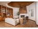 Living room with cozy fireplace, built in shelves and hardwood flooring at 8817 N 58Th Pl, Paradise Valley, AZ 85253