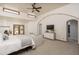 Bright main bedroom featuring a seating area, fireplace, and pool views at 8817 N 58Th Pl, Paradise Valley, AZ 85253