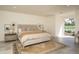 Main bedroom with a spacious layout, tiled floors, and a view to the pool area at 8817 N 58Th Pl, Paradise Valley, AZ 85253