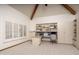 Bright office with built-in shelving, neutral decor, large window and vaulted ceilings with wooden beams at 8817 N 58Th Pl, Paradise Valley, AZ 85253
