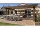 Inviting outdoor kitchen features a stone counter, stainless steel grill, pergola, and dining seating at 8817 N 58Th Pl, Paradise Valley, AZ 85253