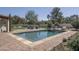 Stunning pool area with brick trim, lush landscaping, and outdoor seating for relaxation and entertaining at 8817 N 58Th Pl, Paradise Valley, AZ 85253