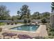 Resort-style pool with brick surround, mature trees, lounge chairs, and a mountain view at 8817 N 58Th Pl, Paradise Valley, AZ 85253