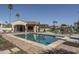 Sparkling pool features a diving board, an outdoor kitchen, and comfortable lounge chairs, perfect for relaxation at 8817 N 58Th Pl, Paradise Valley, AZ 85253