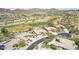 Stunning aerial view of a community with luxury homes along a golf course nestled in the desert mountains at 9440 N Sunset Rdg, Fountain Hills, AZ 85268