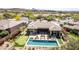 A stunning aerial view of a backyard featuring a sparkling pool, spa, putting green, and outdoor lounge area at 9440 N Sunset Rdg, Fountain Hills, AZ 85268