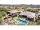 A lovely desert home features a beautiful backyard, pool, putting green and patio area at 9440 N Sunset Rdg, Fountain Hills, AZ 85268