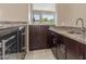 Stylish bar area boasts granite countertops and beverage fridge at 9440 N Sunset Rdg, Fountain Hills, AZ 85268