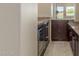 View of stylish bar area with beverage fridge and granite countertops at 9440 N Sunset Rdg, Fountain Hills, AZ 85268