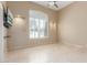 Bright bedroom with large window, neutral paint, vaulted ceiling, and tile flooring at 9440 N Sunset Rdg, Fountain Hills, AZ 85268