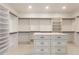 Large closet featuring custom shelves and a central island with drawers for storage at 9440 N Sunset Rdg, Fountain Hills, AZ 85268