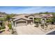 Beautiful exterior elevation showcasing a well maintained desert landscape, a three car garage and neutral paint at 9440 N Sunset Rdg, Fountain Hills, AZ 85268