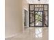 Inviting foyer with a modern glass front door, travertine floors, and a view into the front courtyard at 9440 N Sunset Rdg, Fountain Hills, AZ 85268