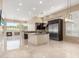 Modern kitchen with stainless steel appliances, granite counters, and open layout to living area at 9440 N Sunset Rdg, Fountain Hills, AZ 85268