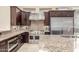 Modern kitchen with stainless steel appliances, custom cabinets and countertops, and tiled flooring at 9440 N Sunset Rdg, Fountain Hills, AZ 85268