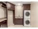 Laundry room featuring stacked washer/dryer, granite counters, and ample storage at 9440 N Sunset Rdg, Fountain Hills, AZ 85268