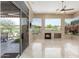 Living room with access to outdoor patio, a fireplace, and scenic backyard views from picture windows at 9440 N Sunset Rdg, Fountain Hills, AZ 85268