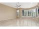 Large, spacious living room with neutral walls, tile floors and picture windows with modern shutters at 9440 N Sunset Rdg, Fountain Hills, AZ 85268
