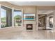 Inviting living room with a fireplace, recessed lighting and a large glass door to the patio at 9440 N Sunset Rdg, Fountain Hills, AZ 85268