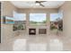 Bright living room with a fireplace and scenic backyard views from large picture windows at 9440 N Sunset Rdg, Fountain Hills, AZ 85268