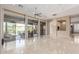 Bright living room with polished floors and large sliding glass doors to outdoor patio at 9440 N Sunset Rdg, Fountain Hills, AZ 85268