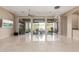 Living room with polished floors, stylish chandelier, and sliding glass doors to outdoor patio at 9440 N Sunset Rdg, Fountain Hills, AZ 85268