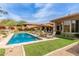 Beautiful pool surrounded by comfortable lounge furniture, lush landscaping, and mature trees at 9440 N Sunset Rdg, Fountain Hills, AZ 85268