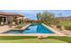 Inviting pool with a putting green, cacti, and desert landscaping at 9440 N Sunset Rdg, Fountain Hills, AZ 85268