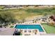 Aerial view of a private pool and putting green surrounded by desert landscaping and lounge seating at 9440 N Sunset Rdg, Fountain Hills, AZ 85268