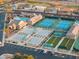 Community featuring tennis courts, bocce ball, pool, and residential homes from an aerial perspective at 10843 E Kilarea Ave, Mesa, AZ 85209