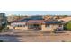 Rear exterior featuring a covered patio, tile roof, and solar panels for energy efficiency at 10843 E Kilarea Ave, Mesa, AZ 85209