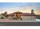 Charming desert home with tile roof, three-car garage, and low-maintenance landscaping at 10843 E Kilarea Ave, Mesa, AZ 85209