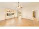 Open living room with tile floors, fan, and archway to the dining and kitchen areas at 10843 E Kilarea Ave, Mesa, AZ 85209