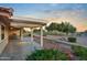 Covered patio with view of beautifully landscaped backyard and golf course at 10843 E Kilarea Ave, Mesa, AZ 85209
