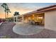 Relaxing outdoor patio with a dining area, beautiful stone, and lush landscaping at 10843 E Kilarea Ave, Mesa, AZ 85209