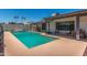 Relaxing backyard with a sparkling pool surrounded by a patio and palm trees adding to the serene setting at 1311 W Palo Verde Dr, Chandler, AZ 85224