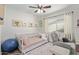 Cozy bedroom with a daybed, ceiling fan, and a comfortable recliner for relaxing at 1311 W Palo Verde Dr, Chandler, AZ 85224
