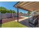 Inviting covered patio with an outdoor dining area and a swing set for play adding to the outdoor living space at 1311 W Palo Verde Dr, Chandler, AZ 85224