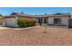 Well-maintained one-story home with desert landscaping, a two-car garage and mature flowering bushes at 1311 W Palo Verde Dr, Chandler, AZ 85224
