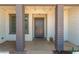 Inviting front porch with support pillars and a gray front door creating a welcoming entrance at 1311 W Palo Verde Dr, Chandler, AZ 85224