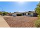 Inviting single-story home with a two-car garage, desert landscaping, and mature trees at 1311 W Palo Verde Dr, Chandler, AZ 85224