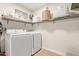 Functional laundry room with modern washer and dryer, shelving, and ample storage space at 1311 W Palo Verde Dr, Chandler, AZ 85224