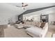 Open living room with wood floors, comfortable sectional sofa, and modern ceiling fan at 1311 W Palo Verde Dr, Chandler, AZ 85224