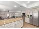Open concept kitchen and living room with recessed lighting and stainless steel refrigerator at 1311 W Palo Verde Dr, Chandler, AZ 85224