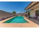 Inviting backyard with a sparkling pool, patio, and privacy fence ideal for outdoor enjoyment and relaxation at 1311 W Palo Verde Dr, Chandler, AZ 85224