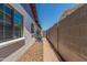 Narrow side yard with brick pavers and gravel, providing a walkway and separation between properties at 1311 W Palo Verde Dr, Chandler, AZ 85224